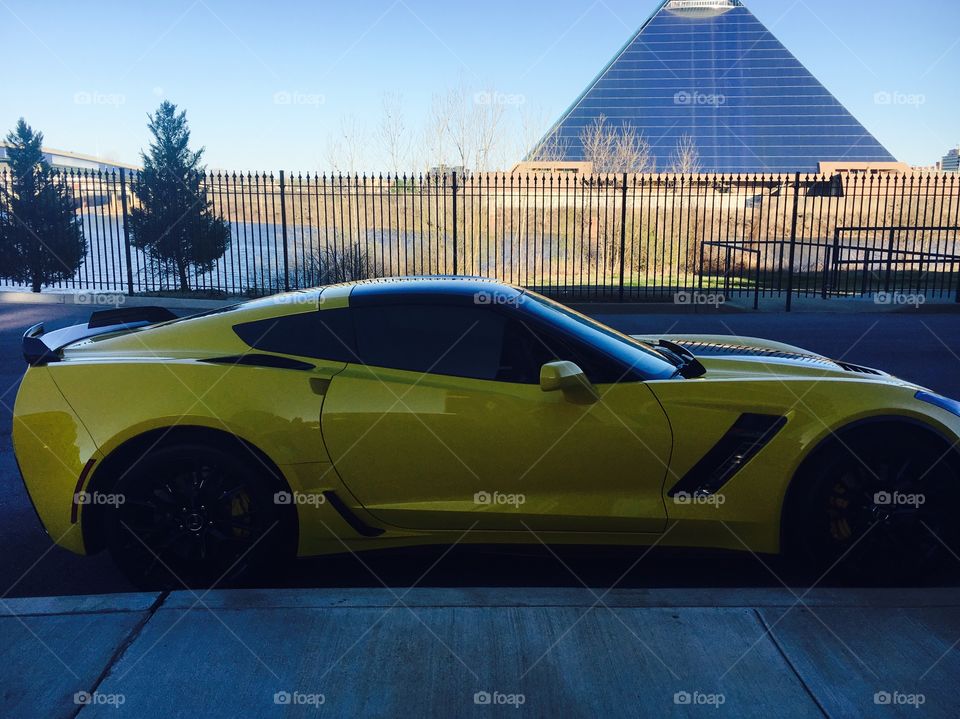 2015 corvette Z06 in Velocity Yellow, sitting across the river from the giant Memphis pyramid