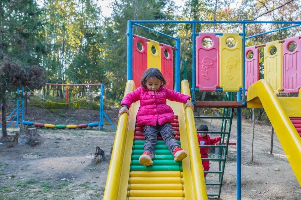 A little girl enjoying slide