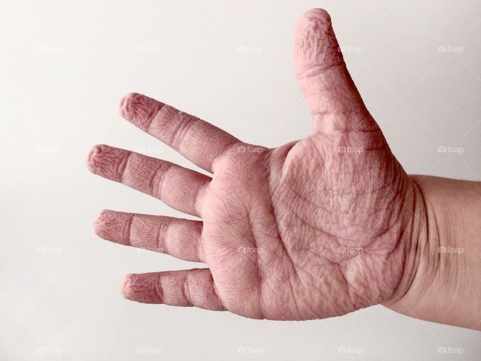 Wrinkled fingers of the kids palm