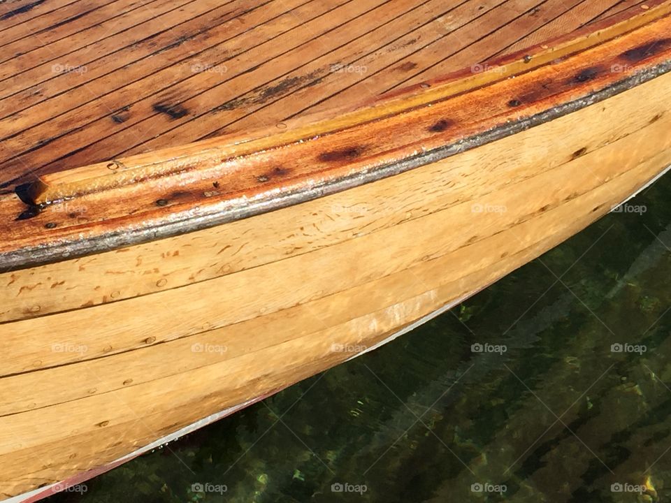 Golden wood. Close-up of a wooden boat in sea.