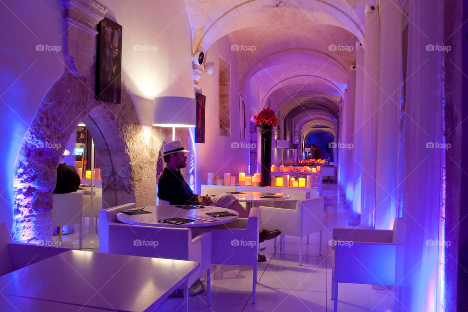 Man seated at a bar or restaurant in France