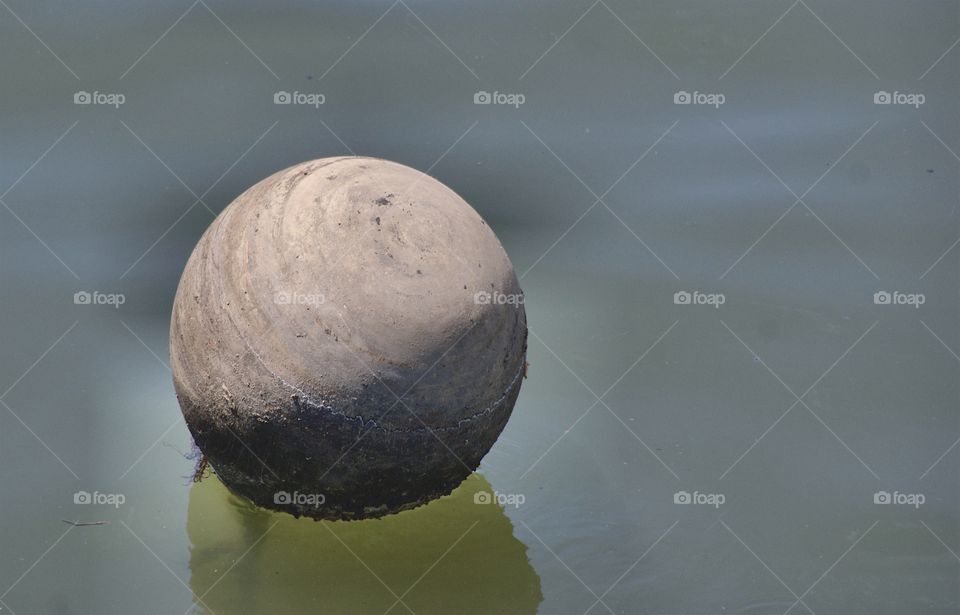 A buoy in the polluted Gowanas Canal, Brooklyn, New York City