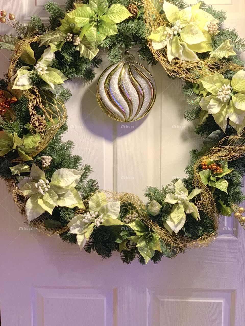 Christmas Wreath on the Front Door - white pointsettia, pine tree needles, ornament 