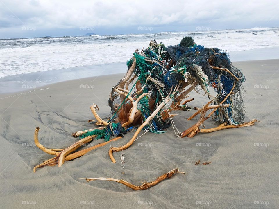 27th January 2025. 7:35am. Location: Cua Dai beach. Hoi an. Vietnam.
Structure built of natural materials, plus fishing materials on the sand.