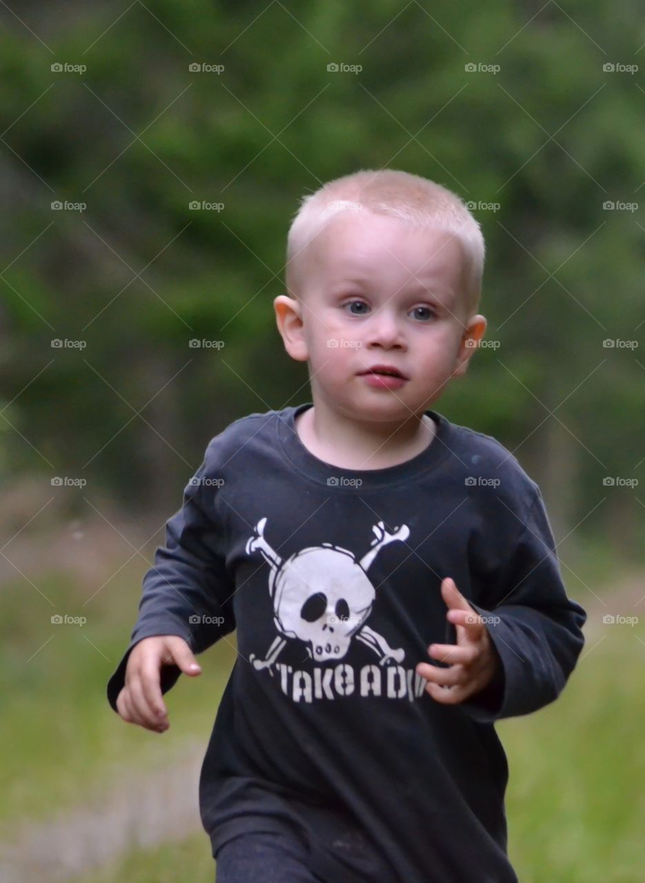 Boy running. A little boy running towards the camera