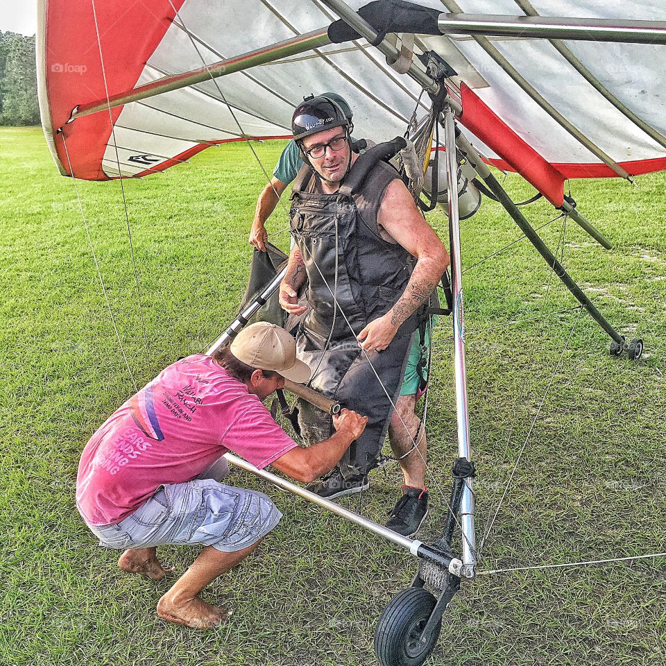 Hang glider on grassy field