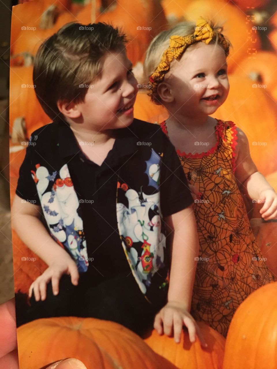 Boy and girl in a pumpkin patch 