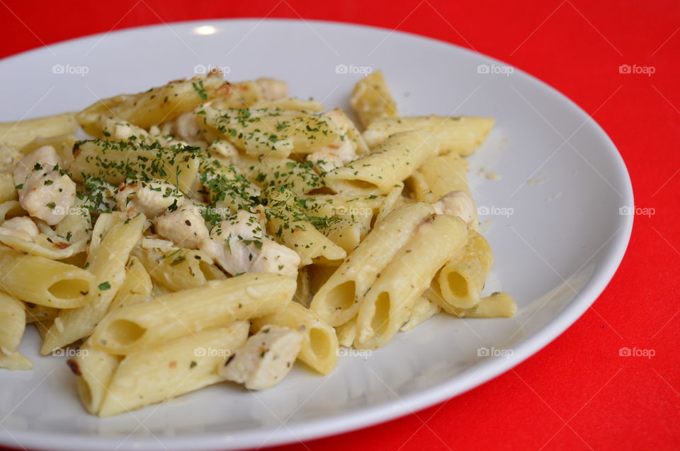 Pasta and chicken meat in plate