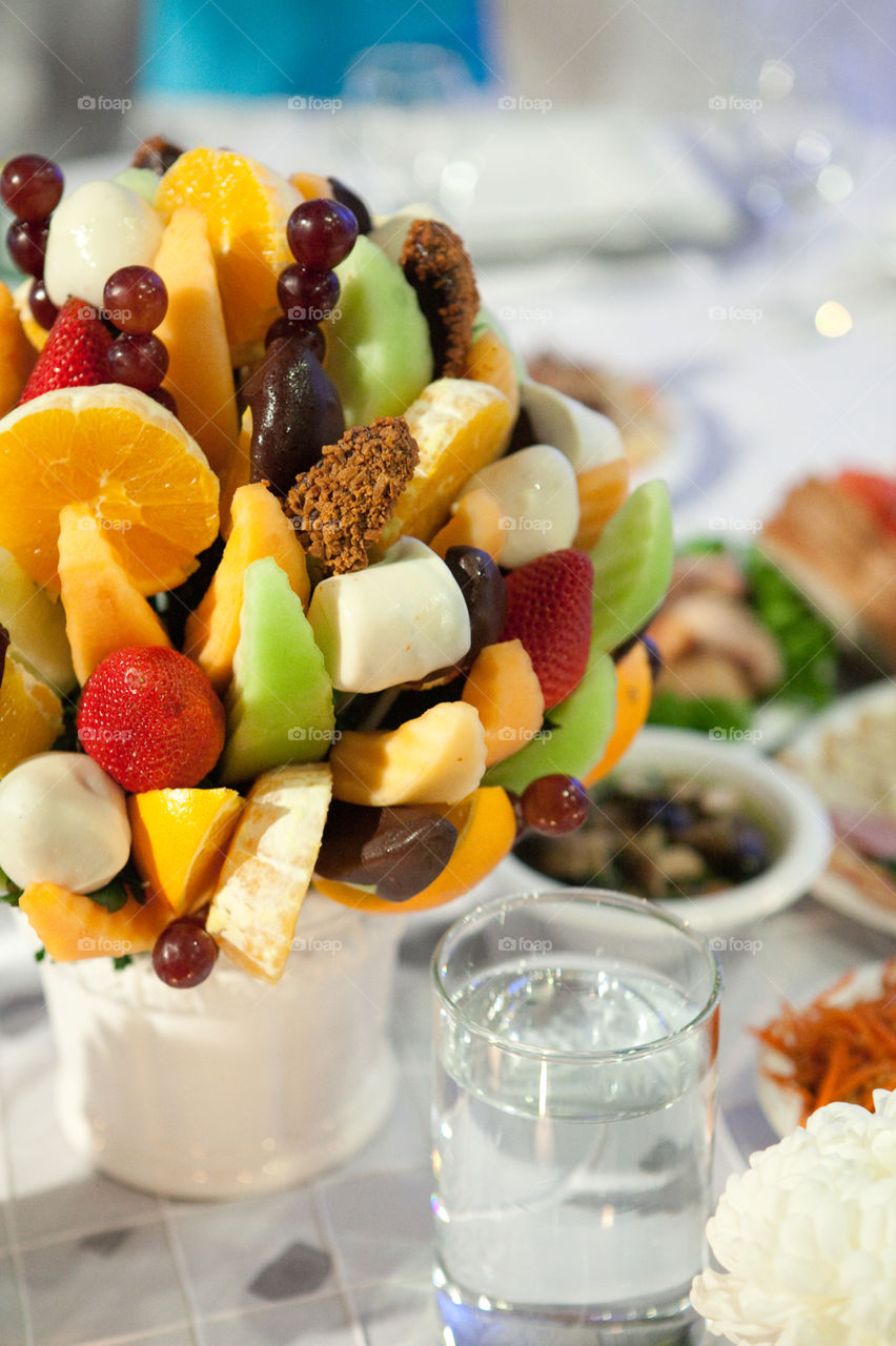 Fruits in a cup cut up on sticks 