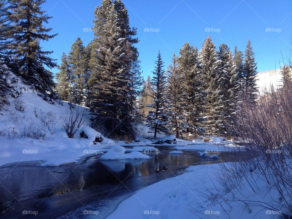 Winter frozen river by the mountain