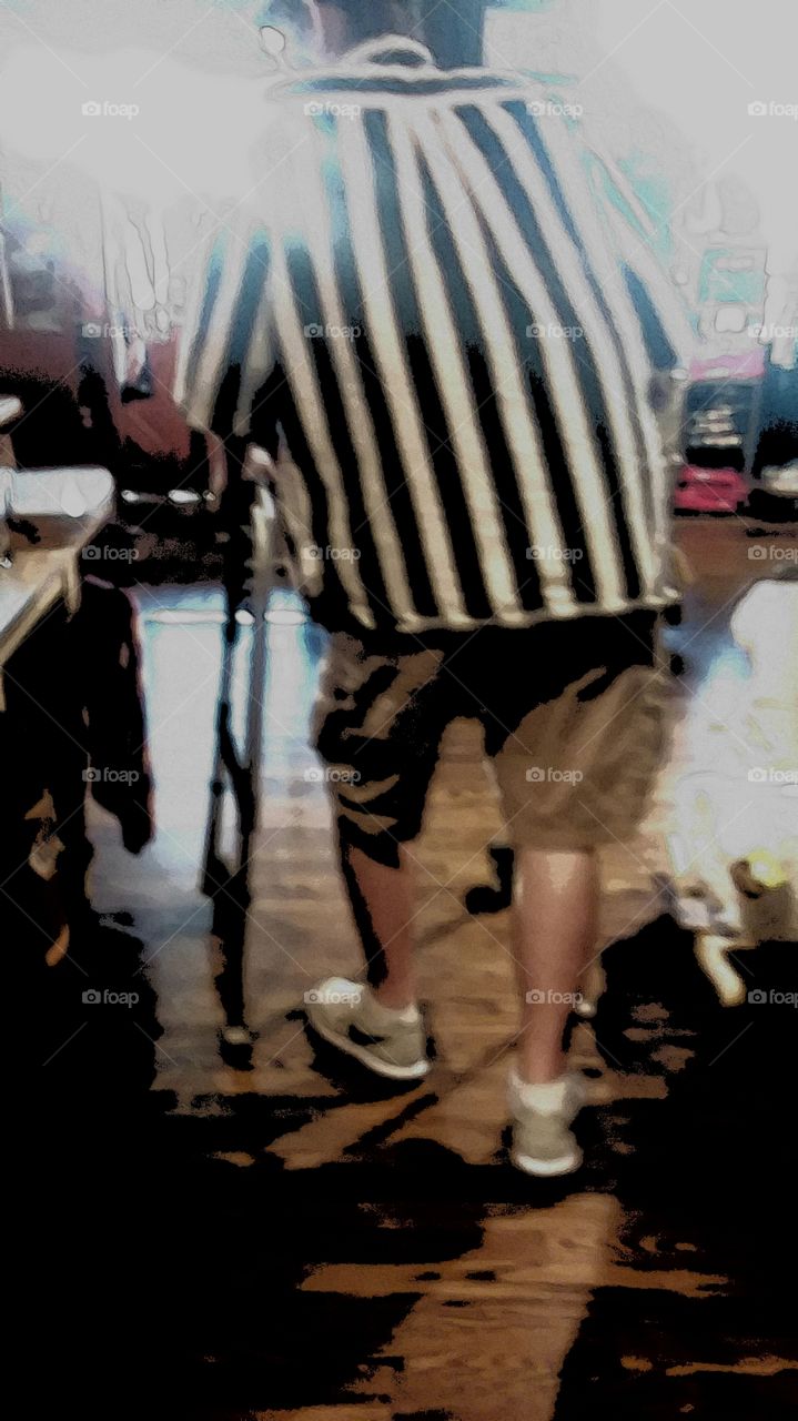 elderly man uses his walker to get from point A to point B through the store to the exit