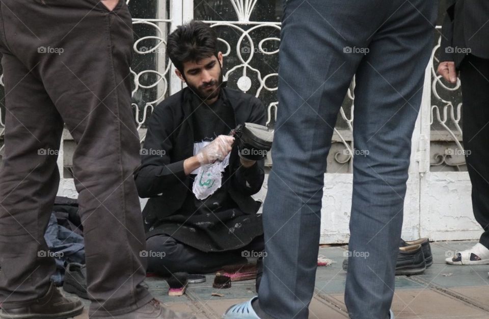 Helpful man and eager father polish others shoes free of charge in special days due to his pure religious believes. Positive energy is surrounding around the world via earth angles. Let's continue charities.