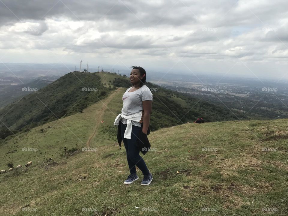 Cloud one person sky wind environment Nature full length Adult Windmill landscape mountain leisure activity day Land Standing adventure Wind power beauty in Nature outdoors Wind Turbine in Ngong, Kenya