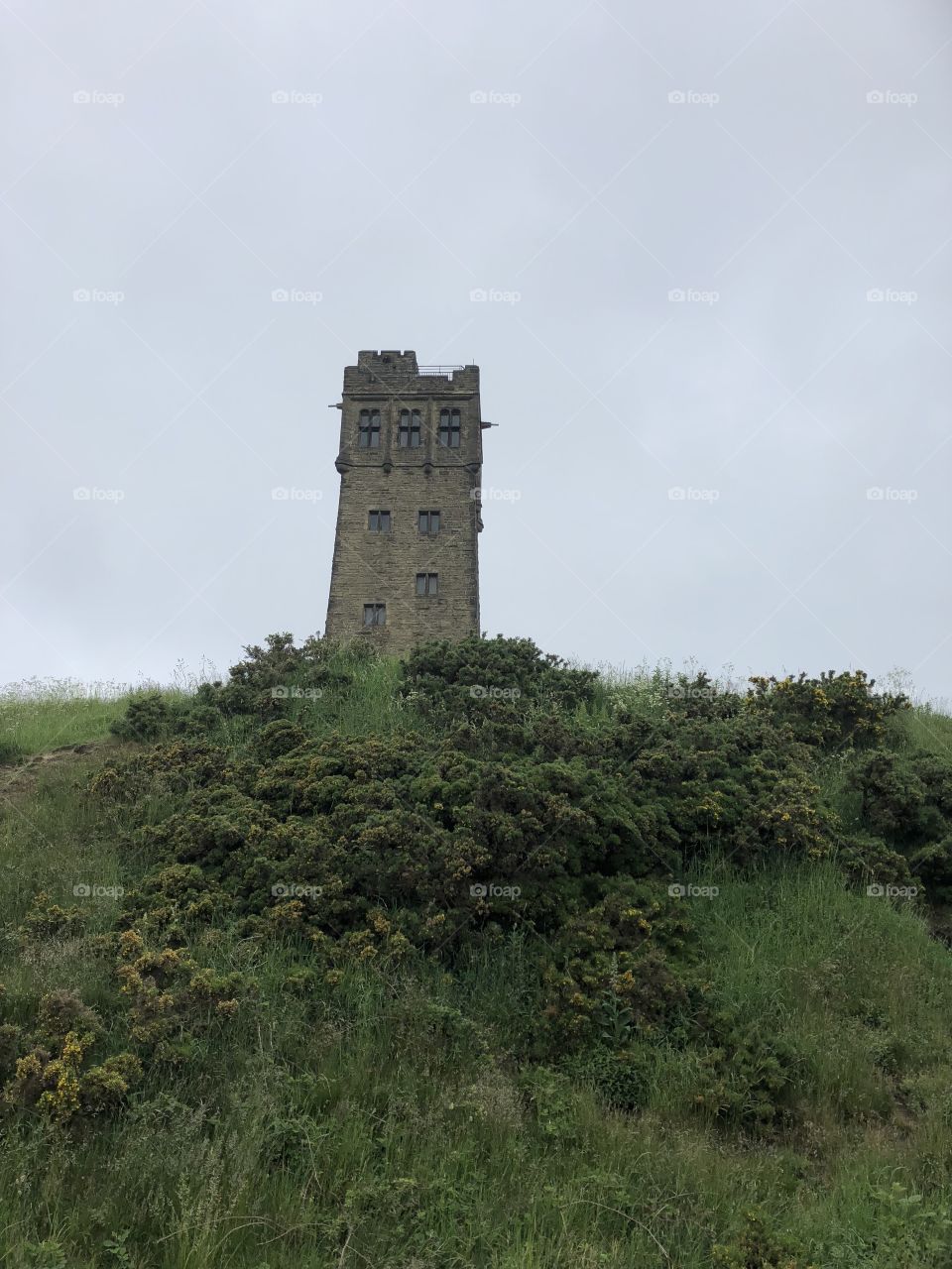 View of Victoria tower on Castle Hill, Huddersfield West Yorkshire, United Kingdom on a stormy spring day. 