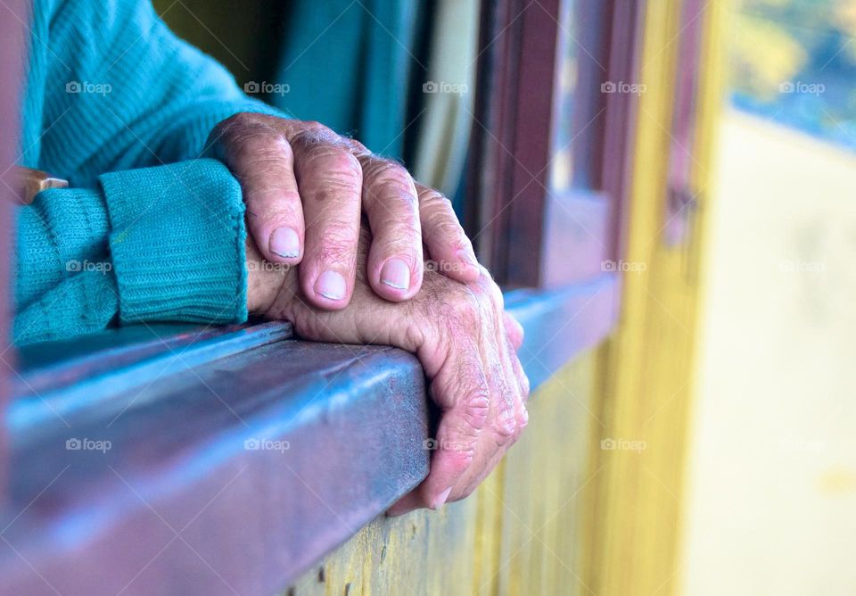 Old hands at the window