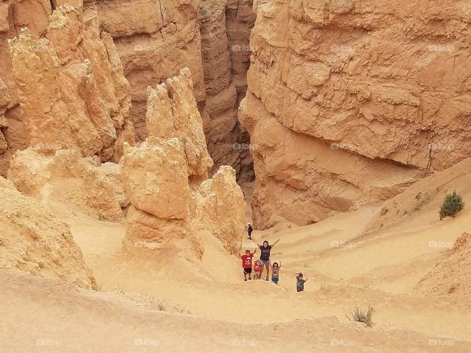 a family down in the canyon among the Bryce Canyon cliffs in Utah 2018