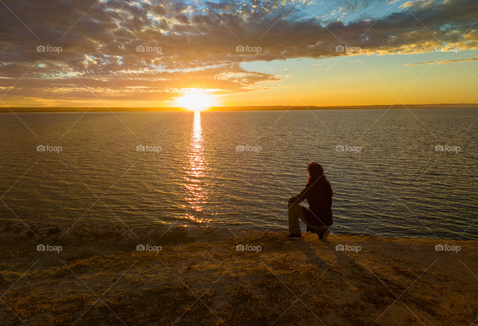 Sunset with the silhouette of a woman