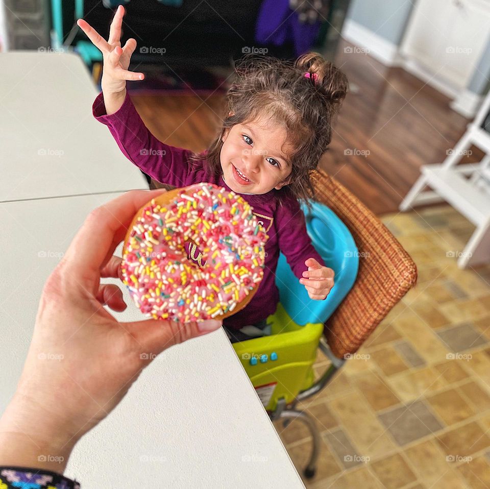 Toddler girl gets excited about donut, circles in every day life, pink frosted donut with sprinkles, little girl wants a treat, eyes on the prize, geometric shapes in your home, sprinkles and toddlers, fun with donuts 