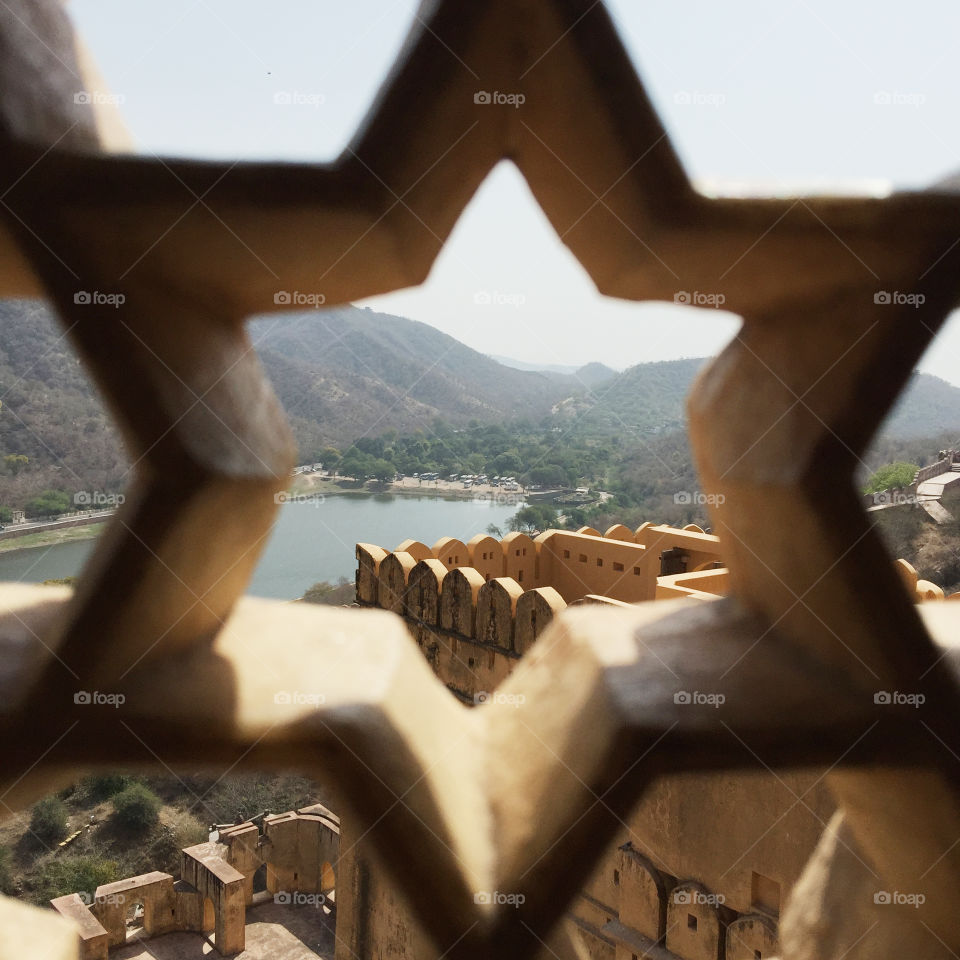 A view of a historical fort seen through a 6 sided star.
