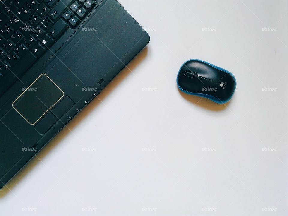 Laptop and computer mouse on a white background