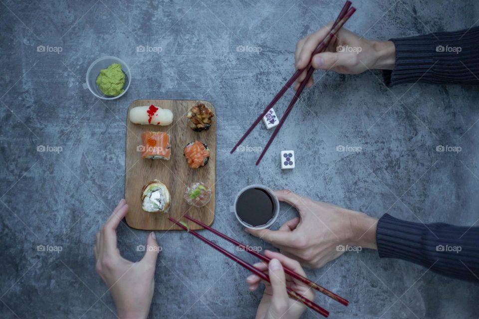 People eating delicious sushi 