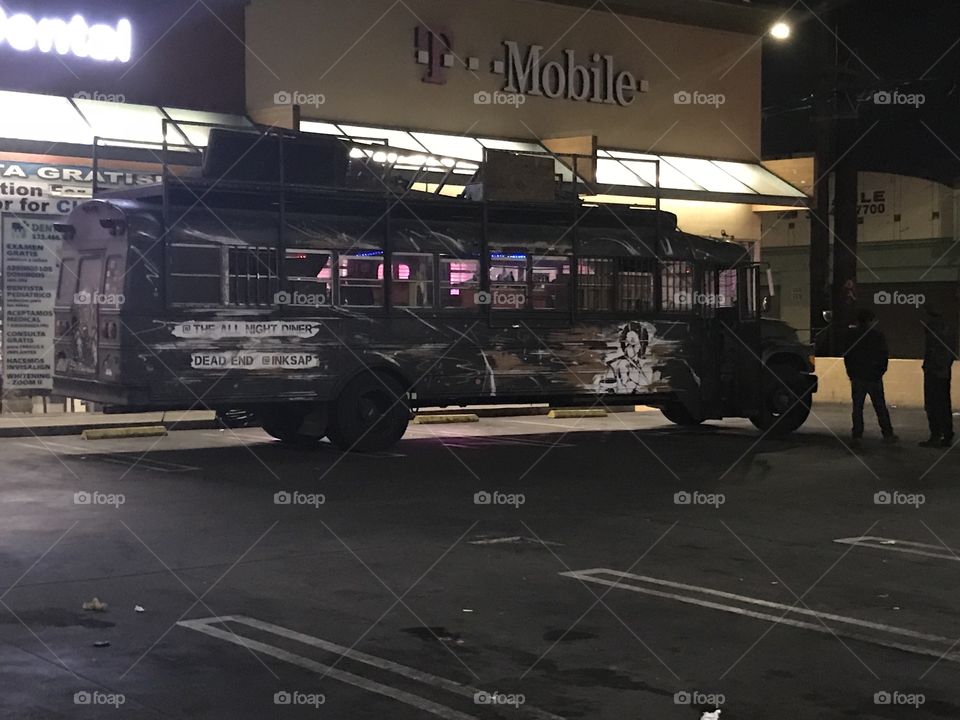 Crazy looking hippie school bus in a parking lot