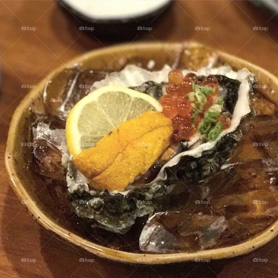 Clam on a half shell with uni and roe