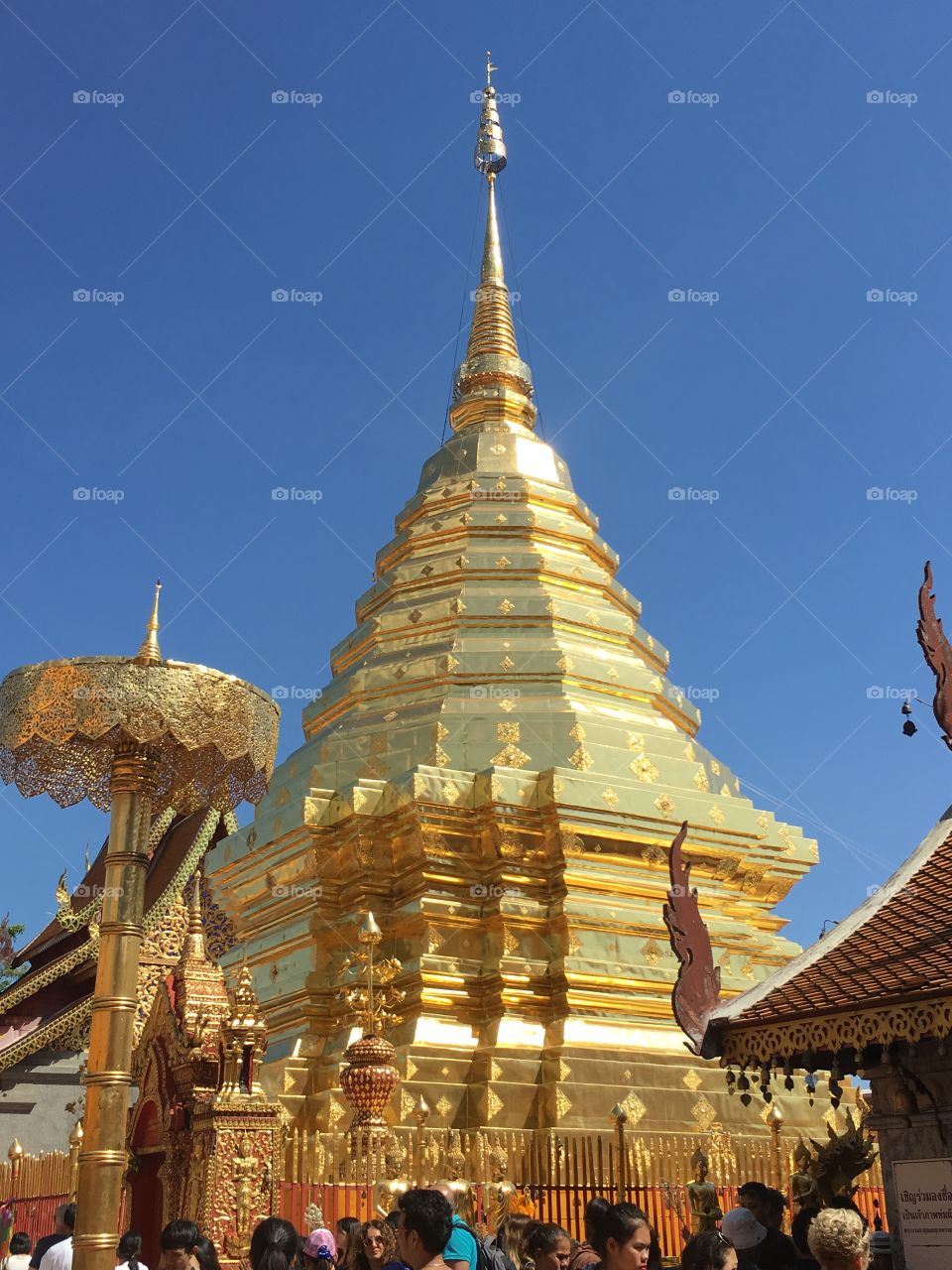 Golden temple in Thailand with blue sky behind