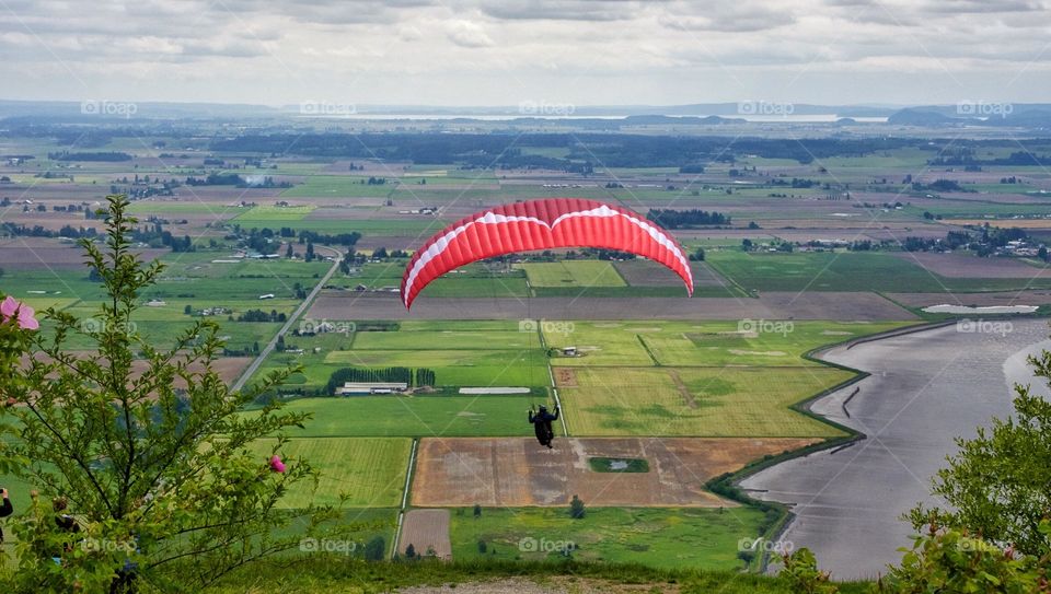 Paraglider over farmland