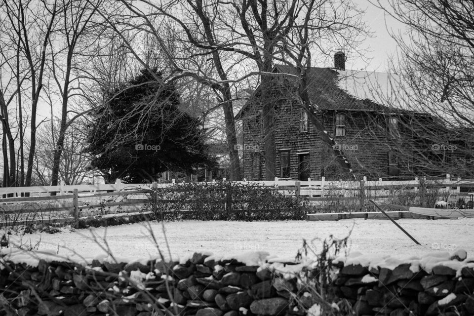 Snow covered farmhouse in the darkness of winter 