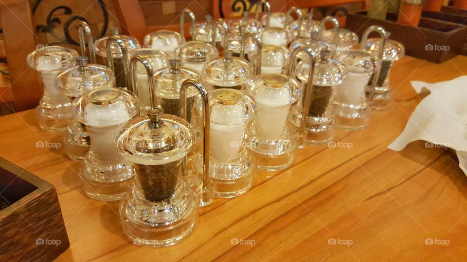 Salt, pepper and oregano. Salt, pepper and oregano in luxury glass bottles set in a rows are ready to serve in pizza resturant
