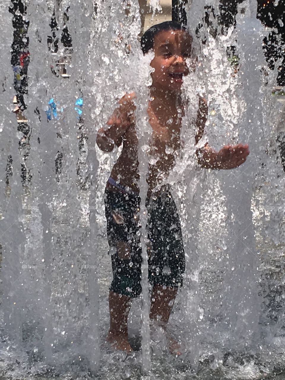 Boy playing in a splash pad 