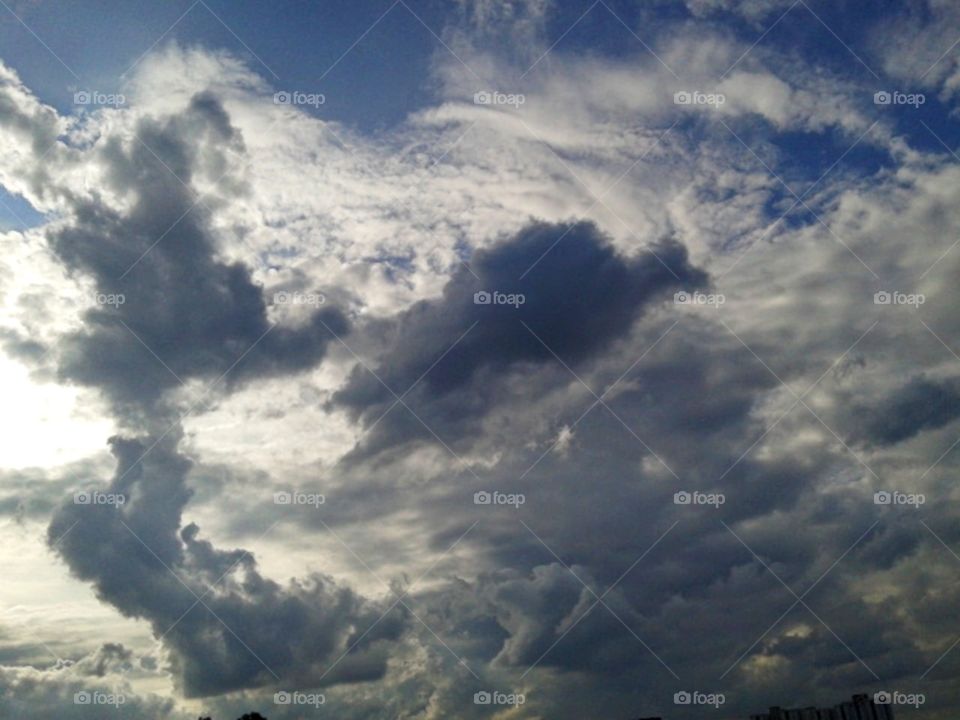 Several little dark dinosaur with the white clouds.