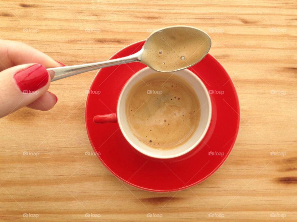 Woman stirring cup of coffee 