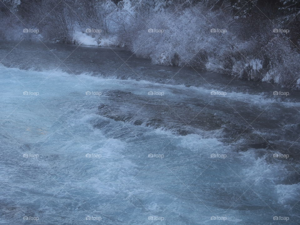 The magnificent Metolius River at Wizard Falls with a morning fog on a cold winter day. 