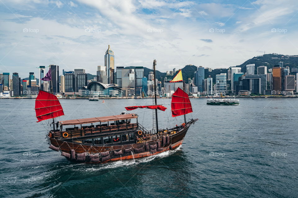 Hong Kong cityscape with Aqua Luna boat at Victoria harbour