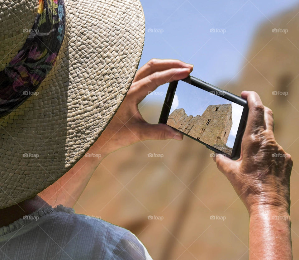 A woman photographing of castle