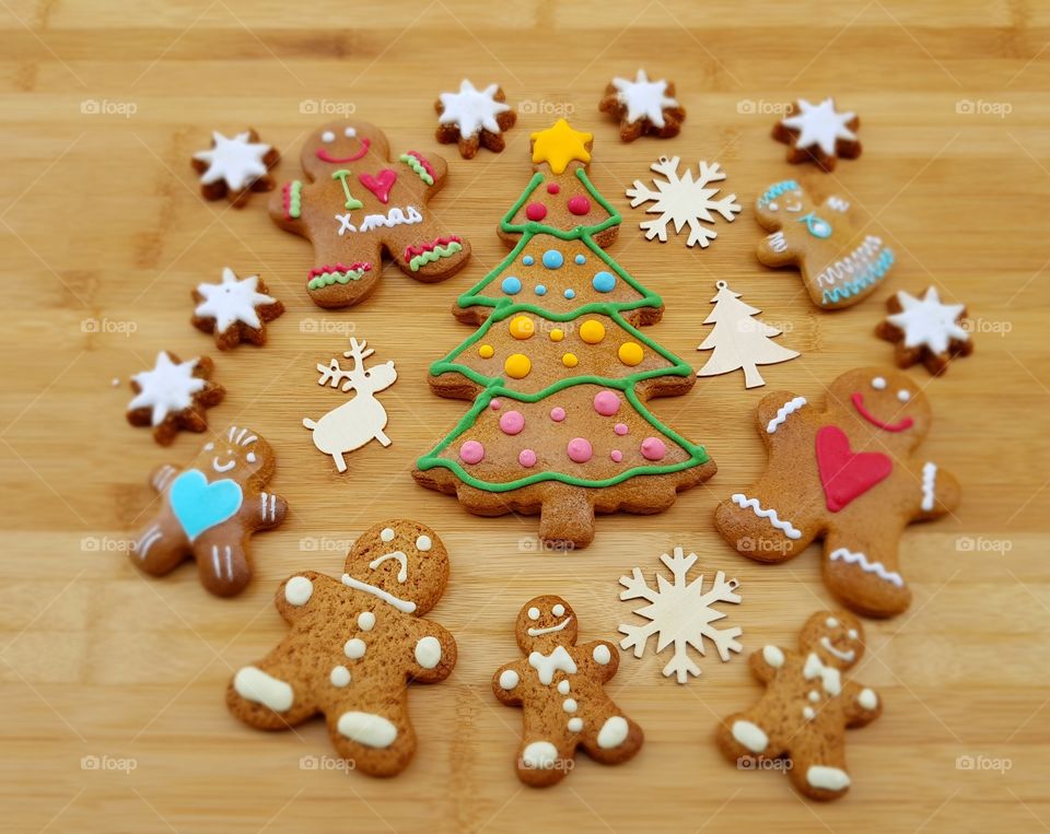 Happy Christmas composition with gingerbread cookies on a wooden board