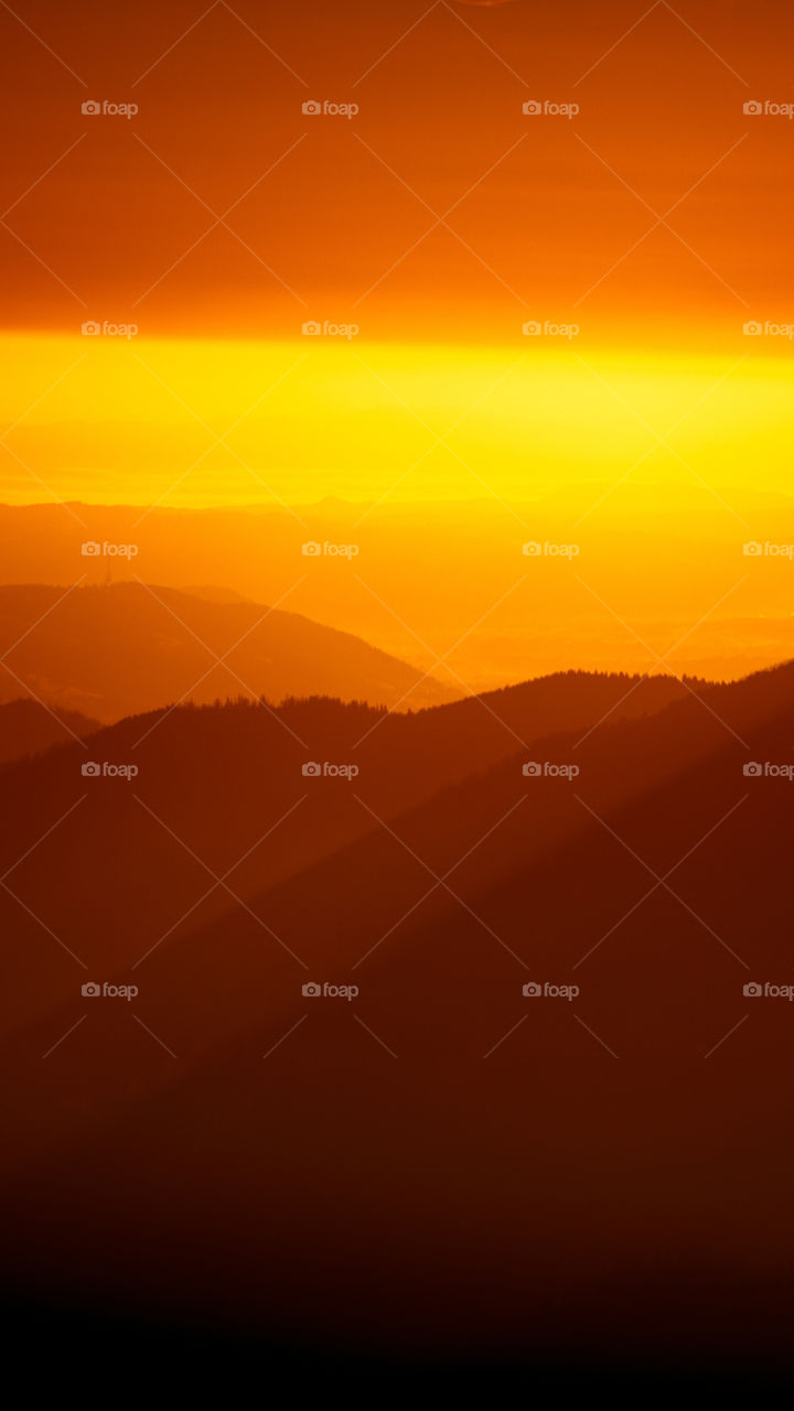 An inspiring red mountain landscape. Tatry mountains in Slovakia. A beautiful wallpaper for smartphone screen. Red abstract gradient with perspective.