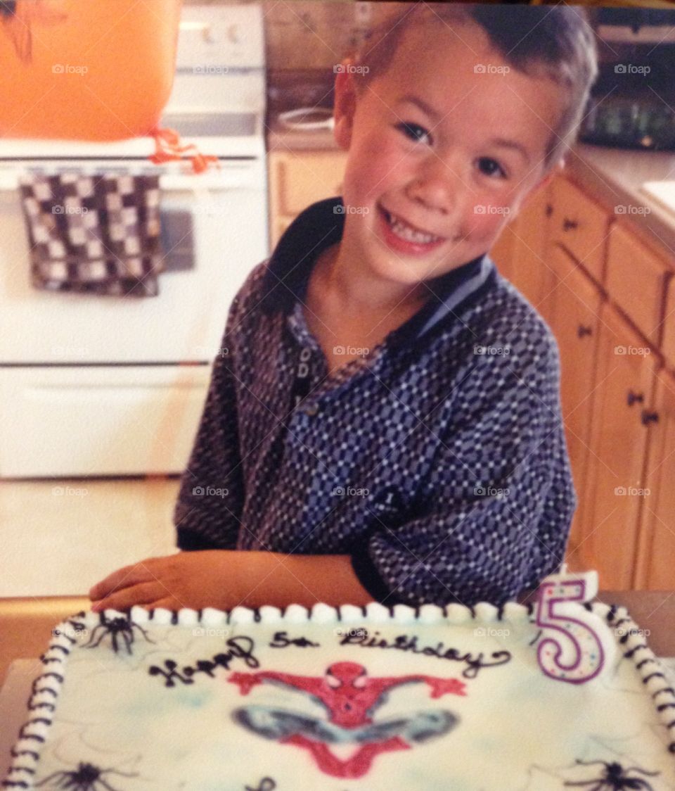 Birthday boy with his Spider-Man cake
