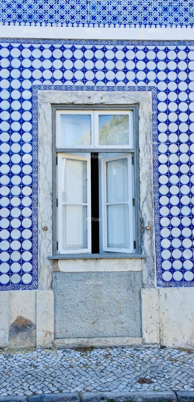 Lisbon, Portugal, front shot of window and typical buildings tiled with famous azulejos ceramic tiles 