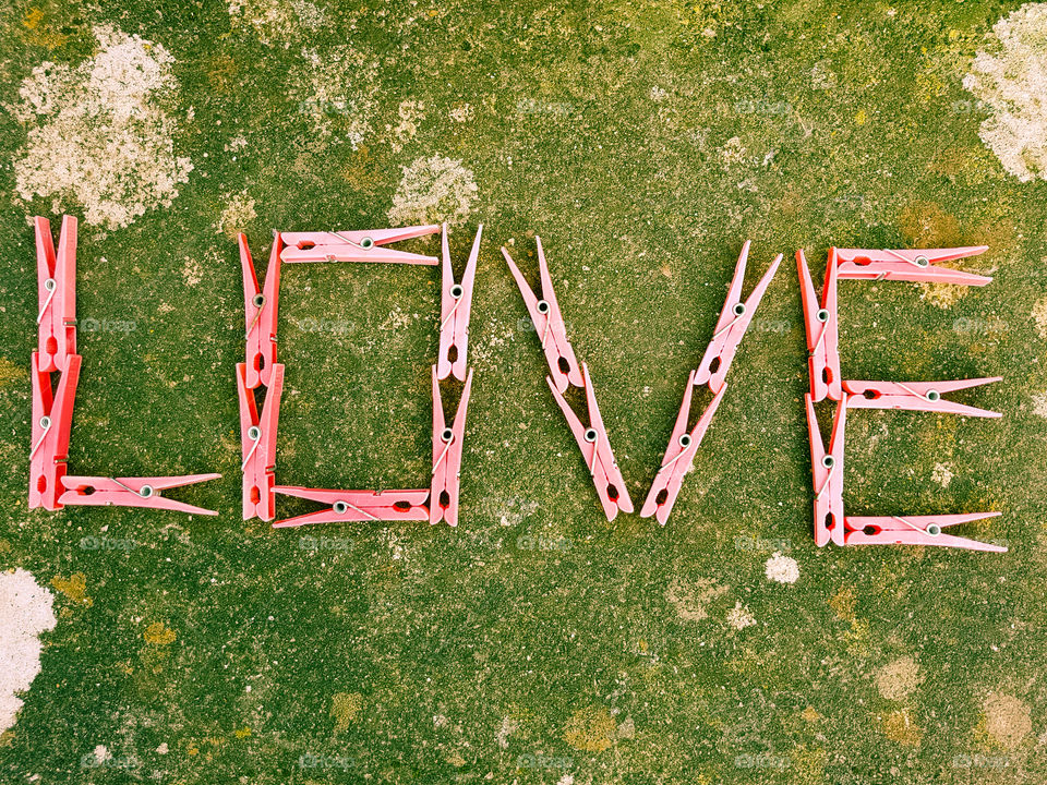 Pink clothespin spelling out the word love