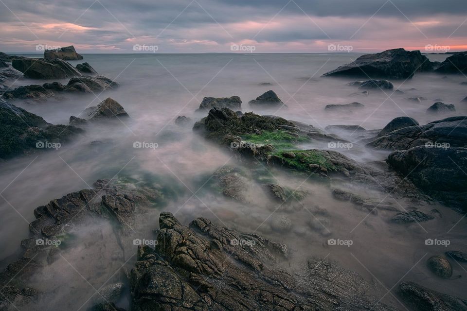 Dramatic sunset scenery of rocky coast at Seaweed beach in county Galway, Ireland