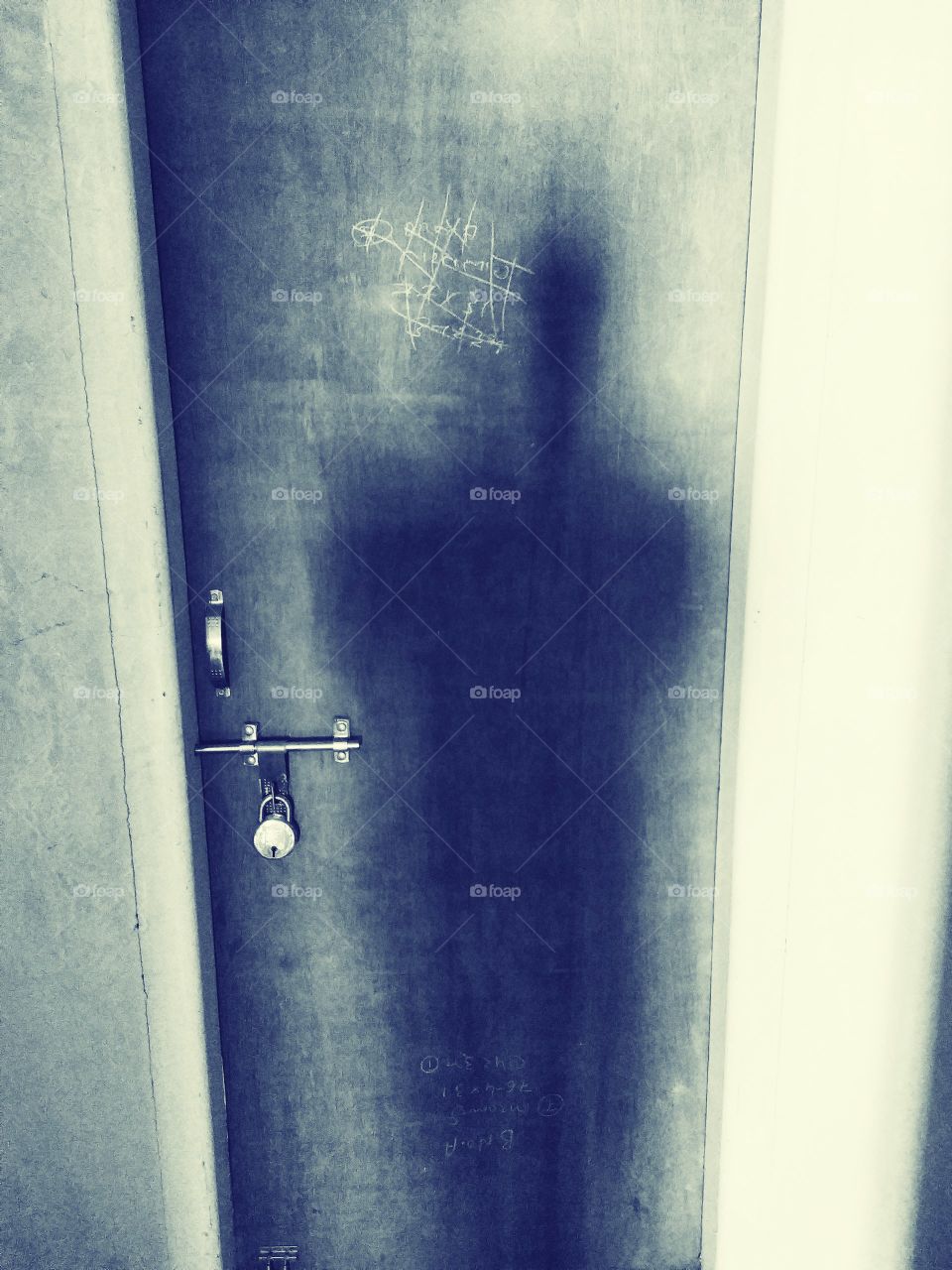 lock door with dark human shadow