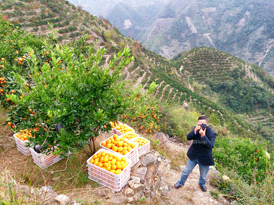 Say Orange!. He captured me and I captured him in Mandarin Oranges mountain in China.