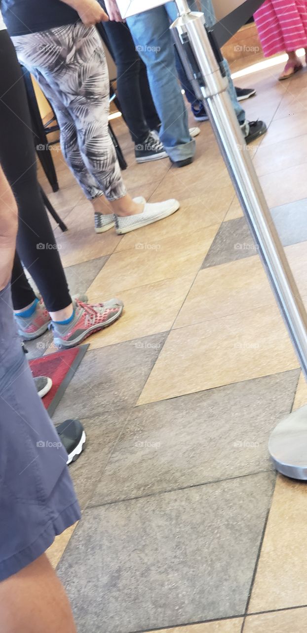 waiting in line at the new location of our favorite donut shop, people in front of me