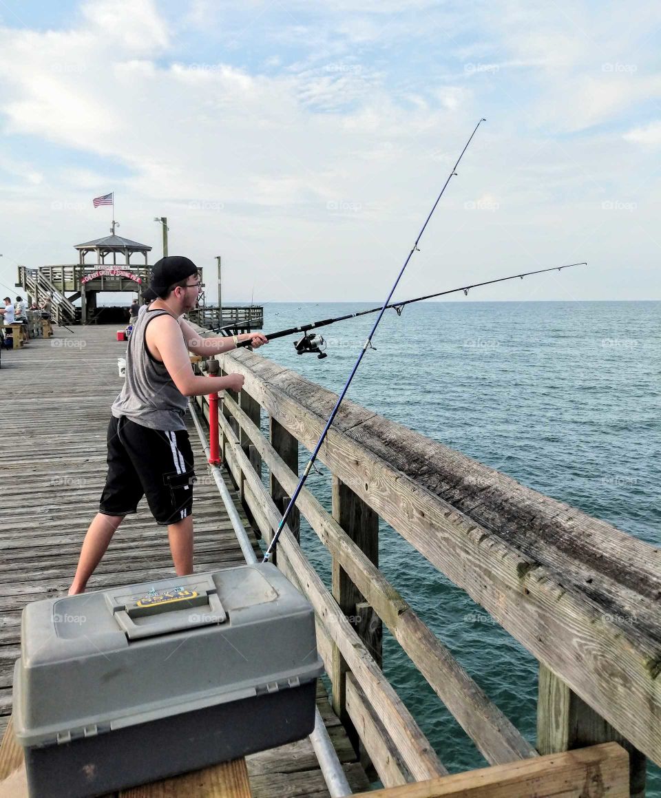 fishing at the pier at the beach