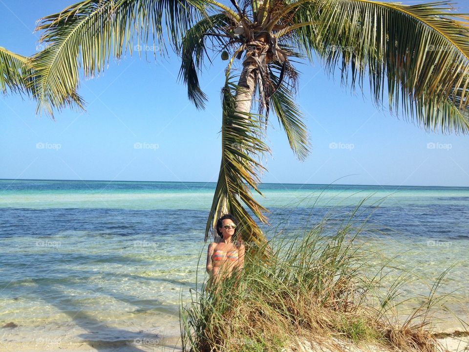 Woman at Bahia Honda,Keys,Florida. woman relaxing under a palm tree at Bahia Honda,Keys,Florida,USA