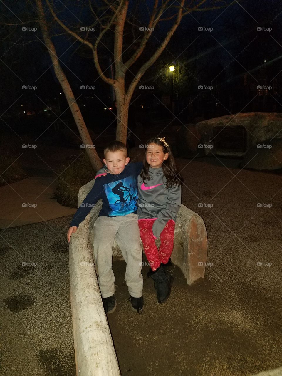 cousins enjoy night time at the park