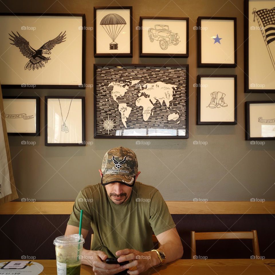 A cafe with a decorative collage wall honoring veterans.